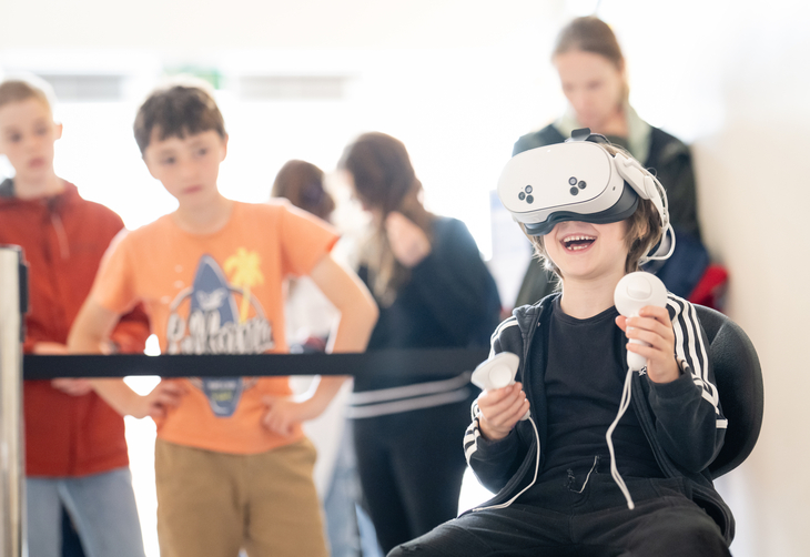A young boy playing on a VR game