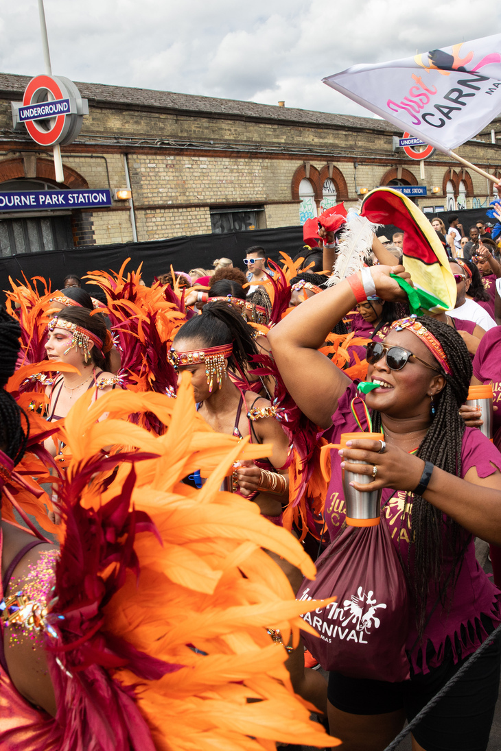 Notting Hill Carnival 2026: People partying in front of a Tube station