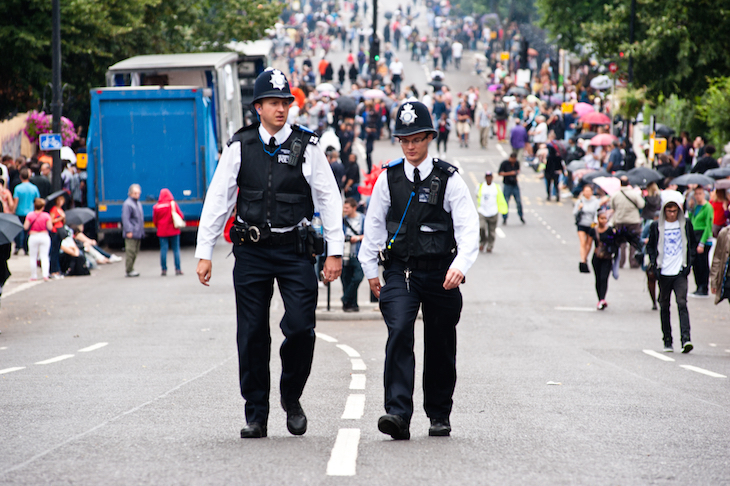 Notting Hill Carnival 2026: two police officers strolling along together during Notting Hill Carnival