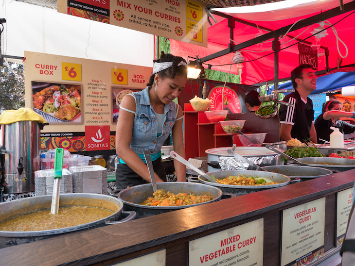 Notting Hill Carnival 2026: a food stall serving curry and roti wraps at Notting Hill Carnival