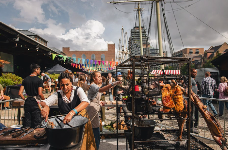 Things to do in London in summer 2026: chefs doing barbecue cooking in the open air at Tobacco Dock
