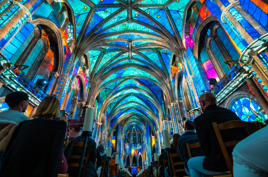 Things to do in London in July 2026: the interior of a cathedral, illuminated in colourful lights
