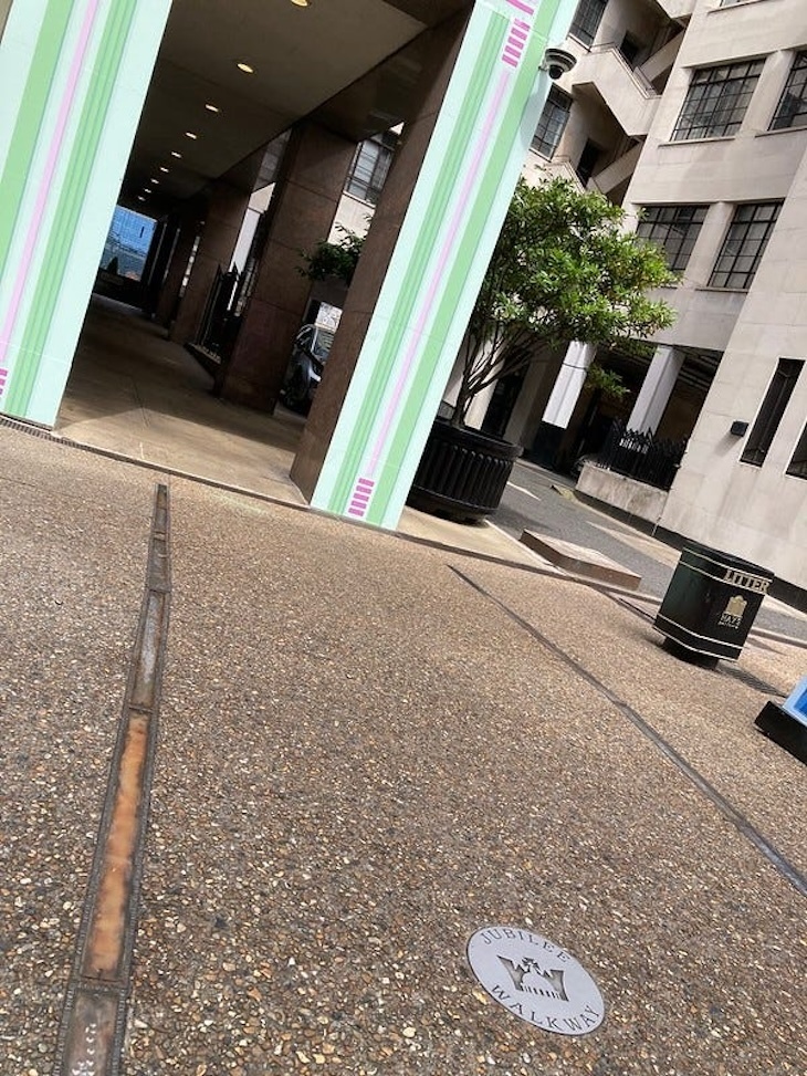 Brass line in pavement showing the course of old london bridge