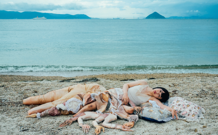 Top events in London in June 2026: Colour photograph of a woman lying on her
side on a beach. Spread out around her are a number of fake
limbs.