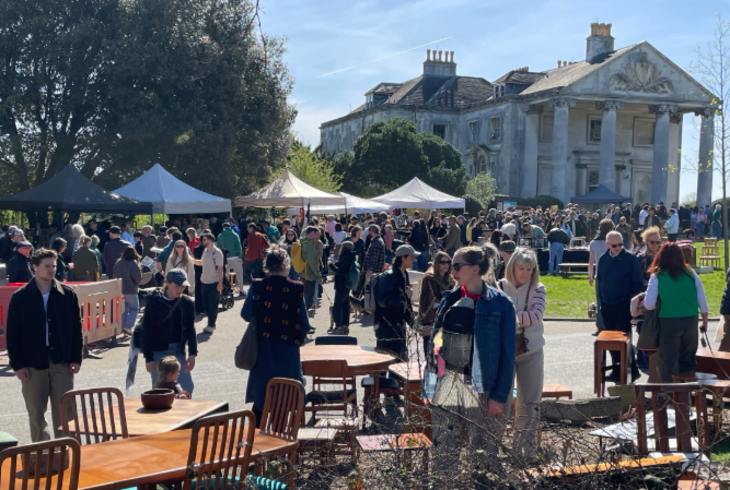 Top bank holiday weekend events London: people browsing stalls at an open-air market in front of a mansion house