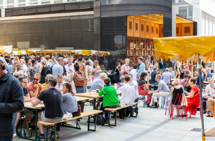Top events in London this weekend: people sitting at picnic benches at an open-air food market