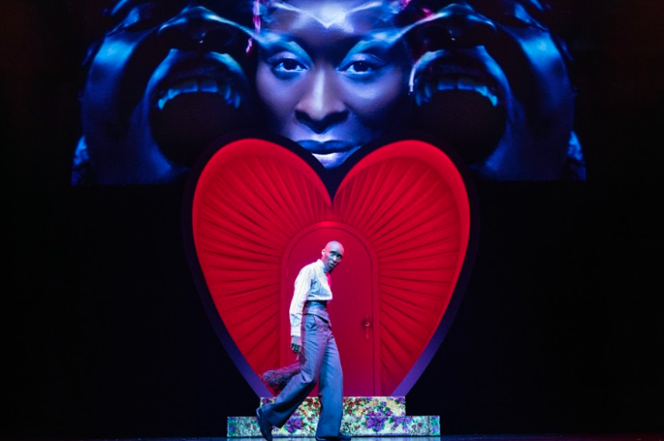 Things to do in London today: Cynthia Erivo walking across a stage in front of a red heart-shaped door