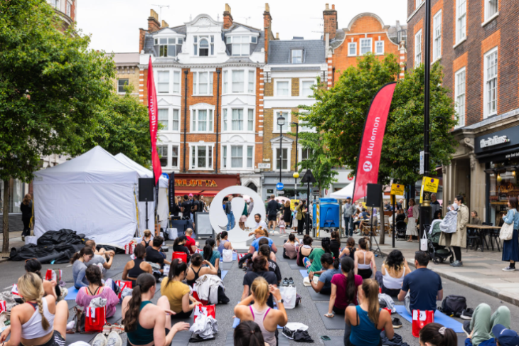 What's on in London today: people sitting on the ground taking part in an open-air Lululemon exercise class