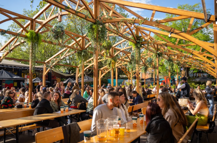 Top events in London today: people sitting beneath an open air pergola in a beer garden