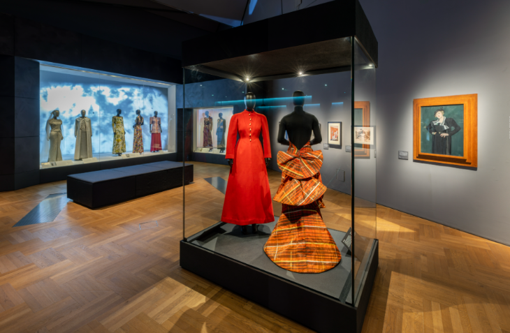 Things to do today in London: dresses on display in a glass case in a museum