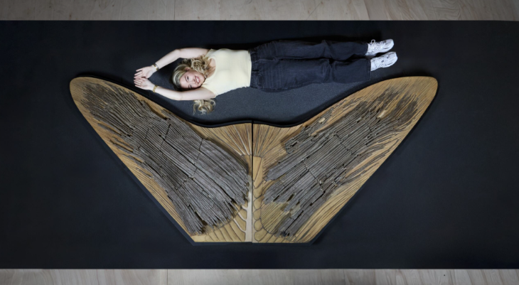 Top events in London today: a woman lying alongside the tail skeleton of a sea creature - the tail is wider than her full height