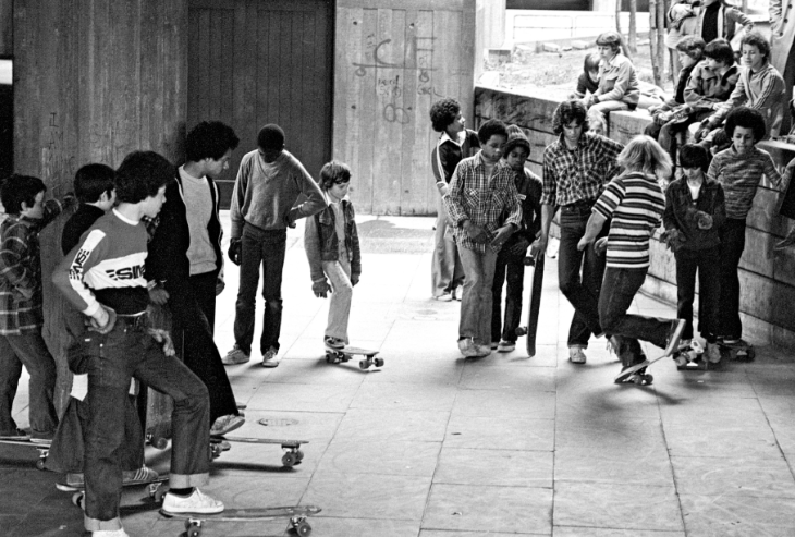 A black and white photo of skateboarders gathered in the Southbank Centre undercroft