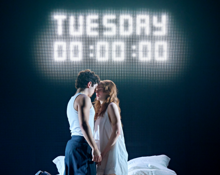 What's on in London in June 2026: Sadie Sink and Noah Jupe beneath  a large digital display saying 