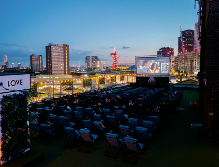 A rooftop cinema at dusk