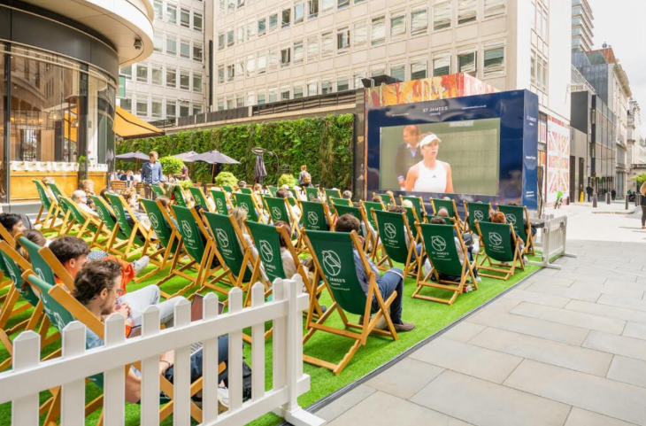 Free screenings of Wimbledon 2026 matches in London: people sitting in neat rows of deckchairs watching tennis on a large screen