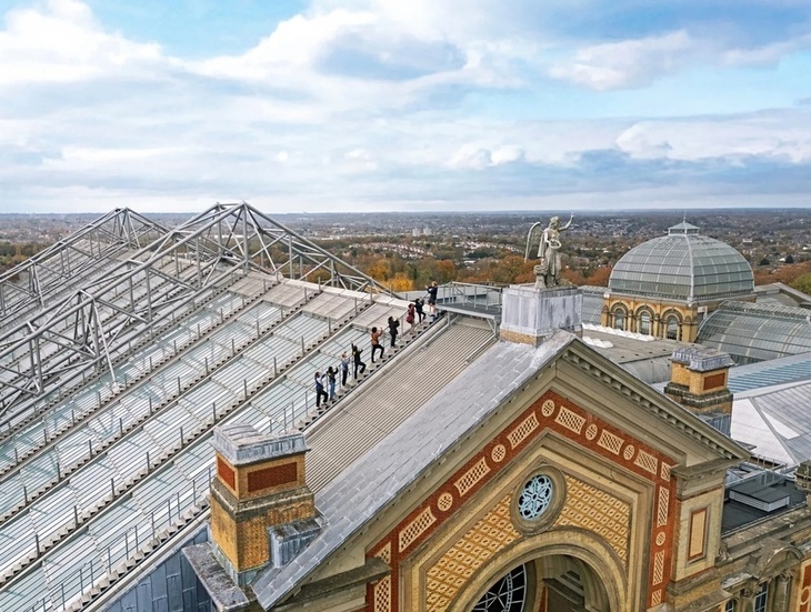 People scaling Ally Pally