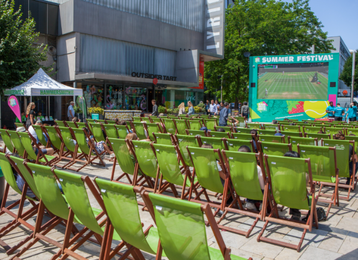 Free screenings of Wimbledon 2026 matches in London: rows of green deckchairs set up in front of a large screen in Hammersmith