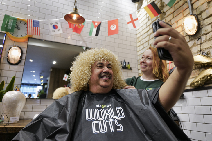 A person getting peroxide blond curls in a barbershop