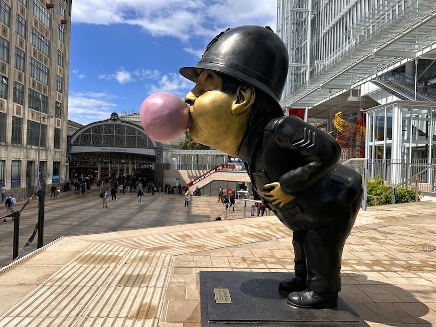 A policeman blowing a bubble sculpture