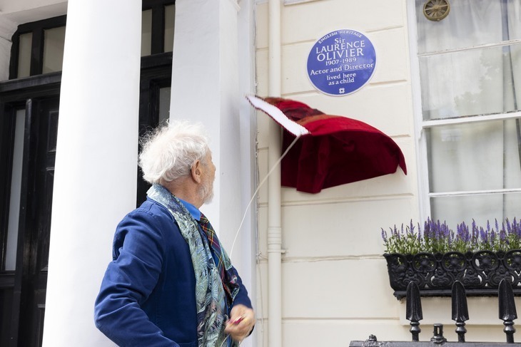 Sir Ian McKellen appears to be flying his kite too low. It collides with a blue plaque to Laurence Olivier