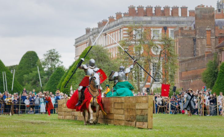 What's on in London this weekend: people dressed as knights taking part in a joust on horseback, watched by a crowd in front of Hampton Court Palace