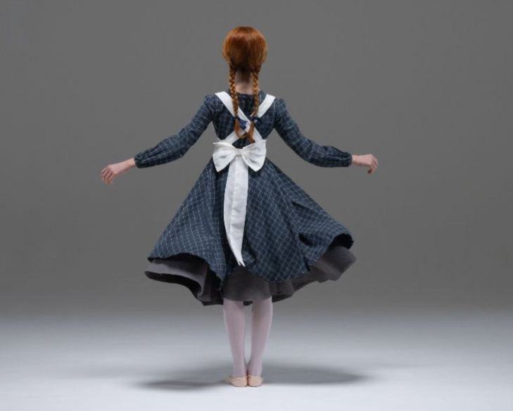 Top events in London today: a back view of a young girl in a blue check dress with two plaits in her hair