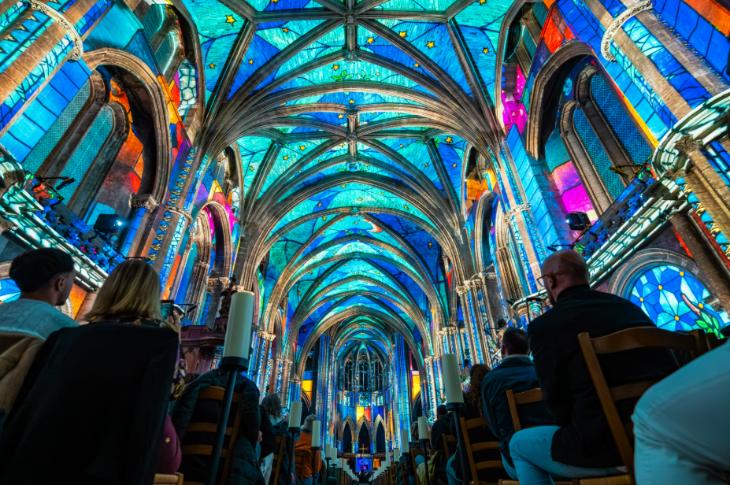 Top events in London today: people sitting in pews in a cathedral looking up at illuminations on the ceiling