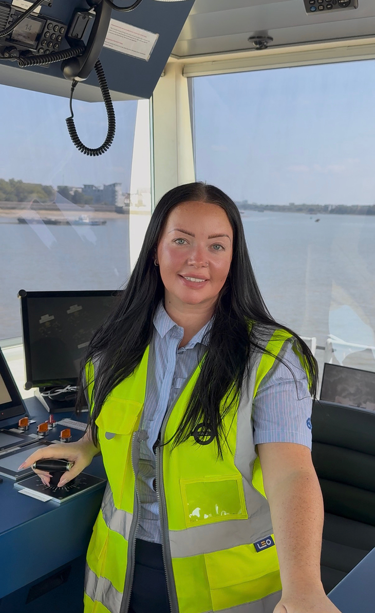 A woman in high vis captaining the ferry