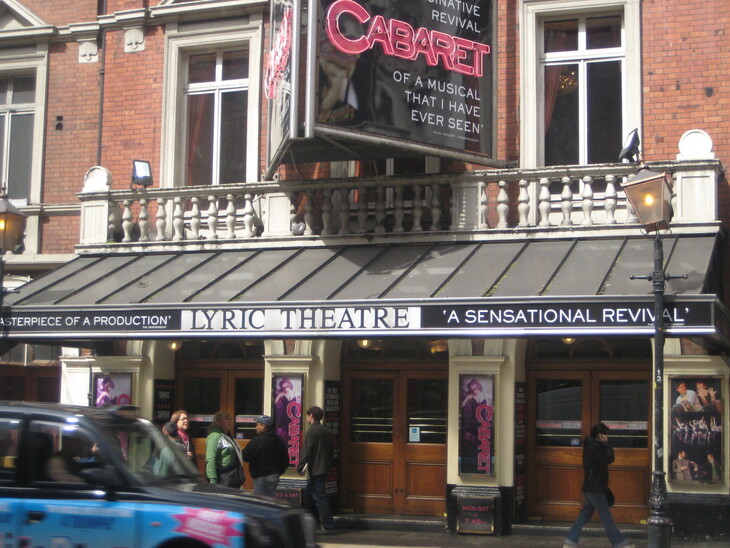 The exterior of the Lyric Theatre in London, featuring a large marquee for the musical Cabaret and people walking past the entrance.