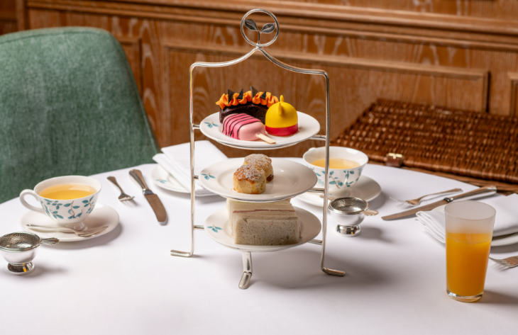 London's best afternoon tea;: a tiered afternoon tea stand loaded up with Winnie the Pooh themed treats