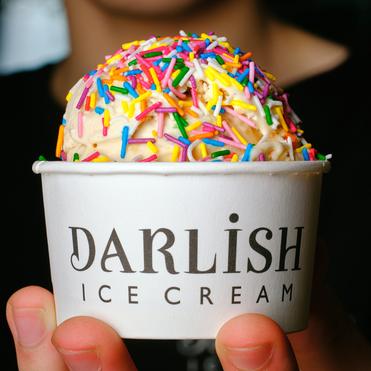 A tub of ice cream covered in sprinkles