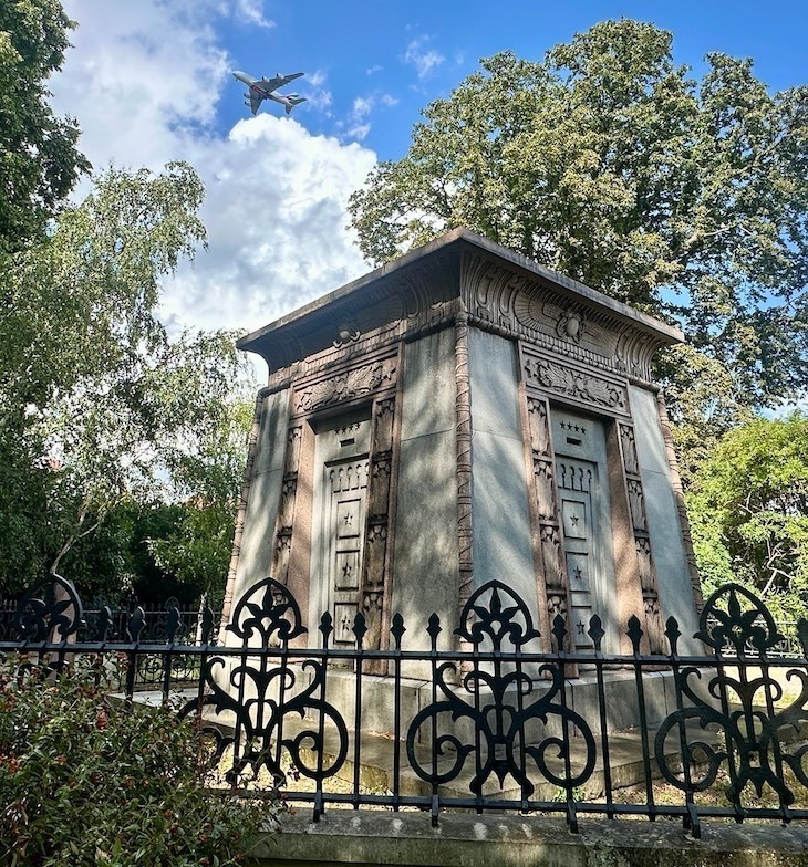 An ornate tomb behind railings