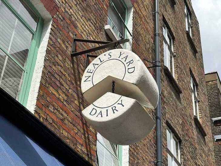 Neals Yard hanging sign of some cheese