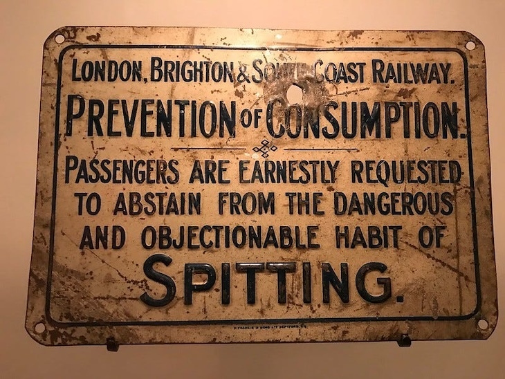 A sign prohibiting spitting to prevent consumption.