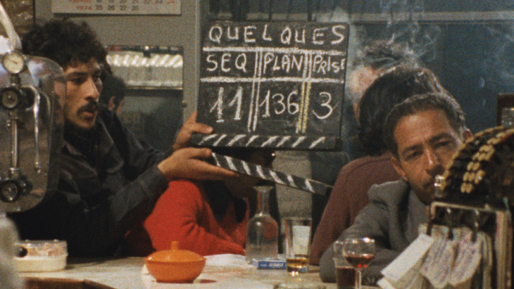 A person holding up a chalk film clapperboard