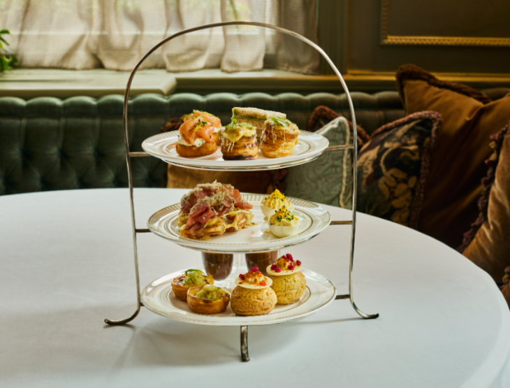 Best places for afternoon tea in London: a three-tiered afternoon tea stand on a table with a white cloth