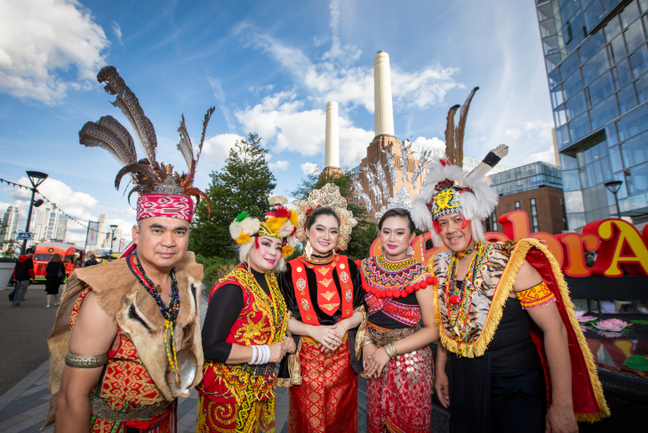 September 2026 top events in London: five people in traditional Asian costumes posing for a photo in front of Battersea Power Station