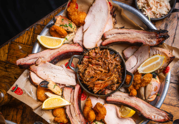 A plate of meat including ribs and chicken wings