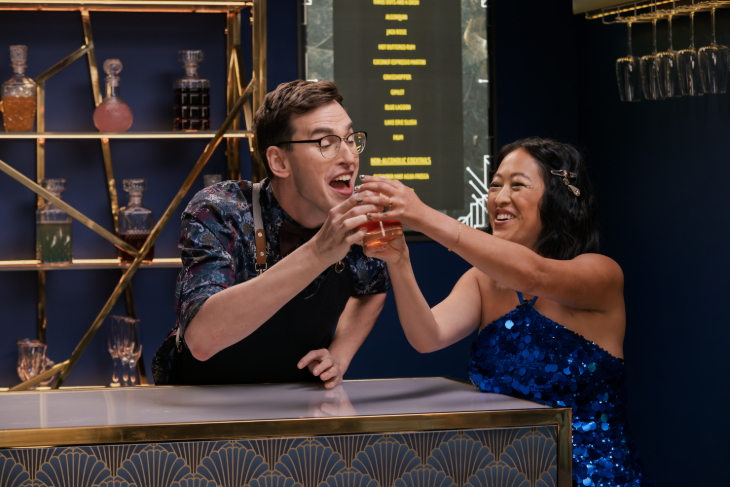Two people seeming to argue over a single glass of drink