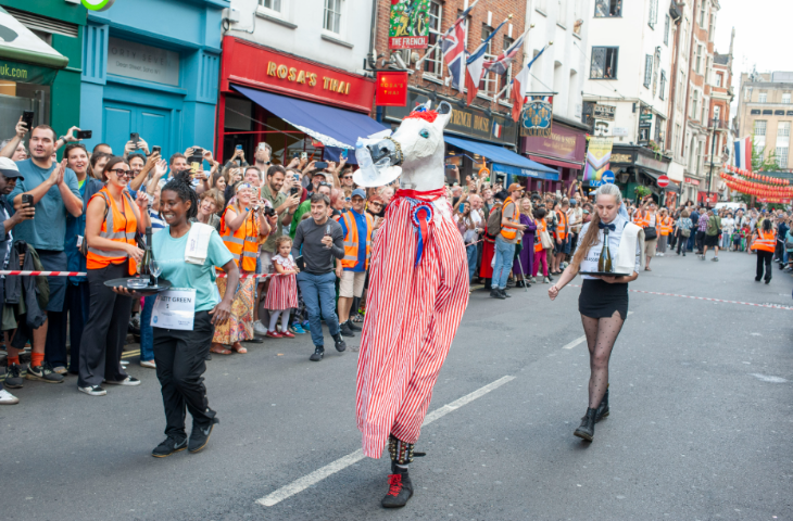 Things to do in London today: someone dressed as a horse taking part in the Soho Waiters' Race, watched by crowds.