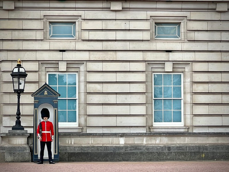 A guard standing duty in a sentry box outside Buckingham Palace