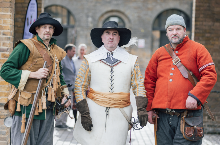 Three people in historical costumes