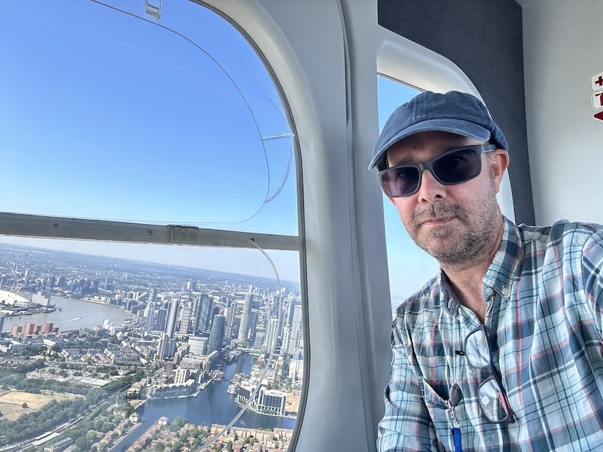 Matt Brown of Londonist beside an open window on the Goodyear blimp
