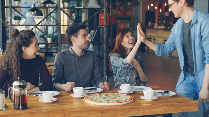 Four friends meeting over coffee and pizz