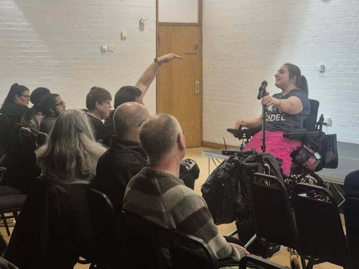A comedian in a wheelchair doing stand up