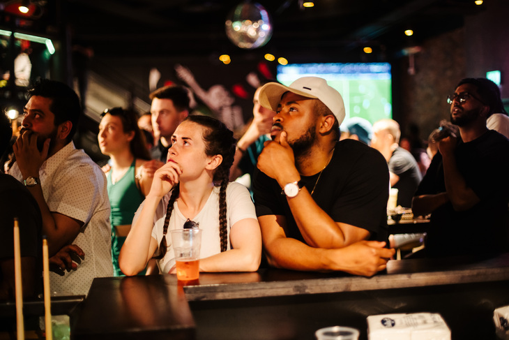 People looking serious watching a game