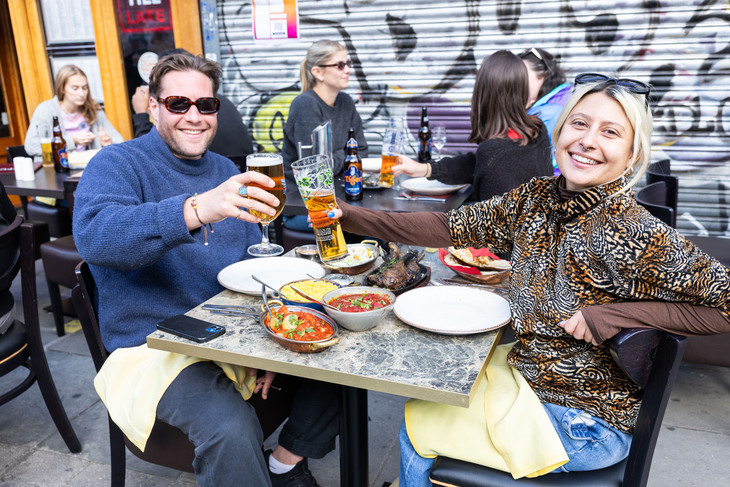 People enjoying a curry on the street
