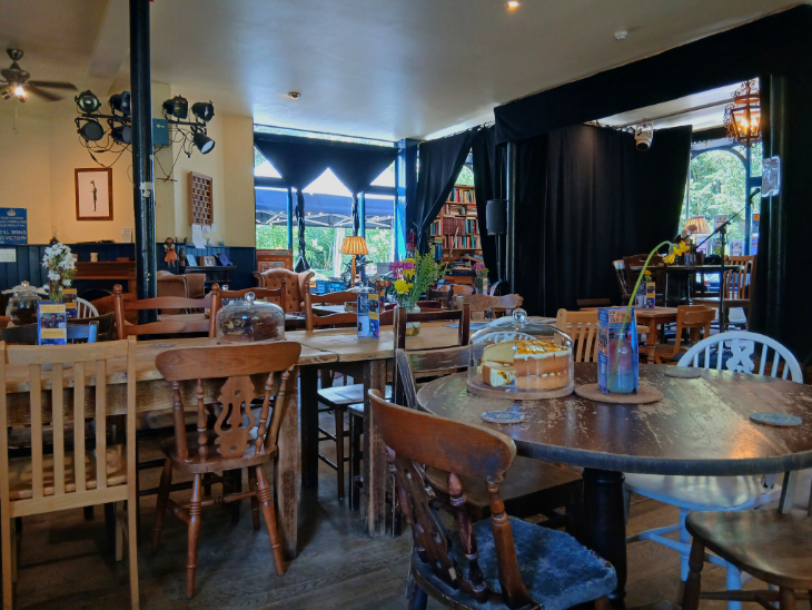 Best budget afternoon tea London: the interior of the Tea House Theatre, a cafe with wooden tables and chairs