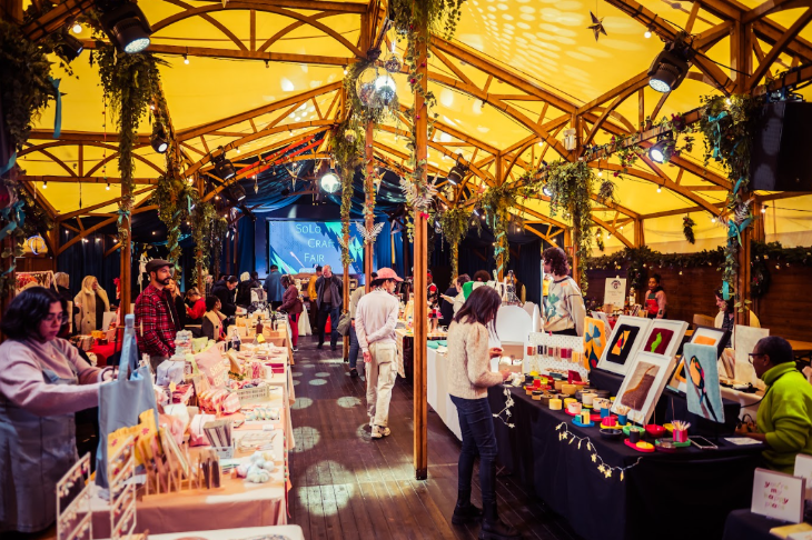 London Christmas markets and fairs 2026: people browsing a Christmas market inside a marquee
