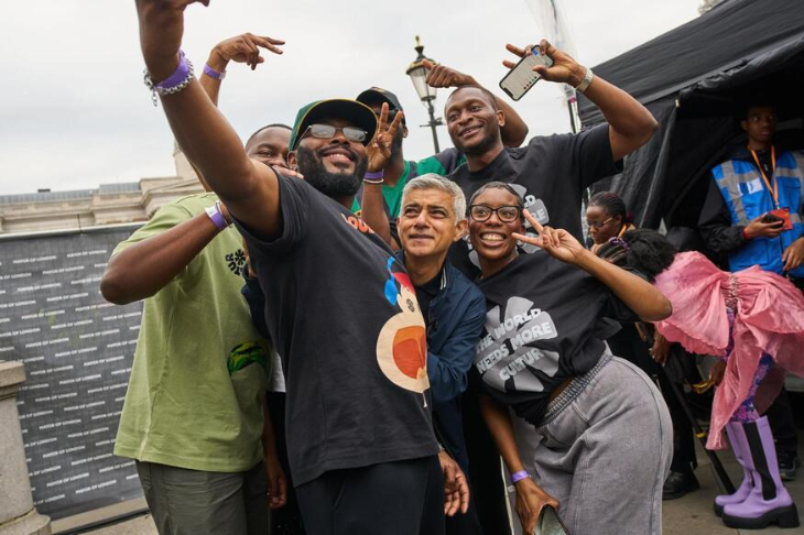 A crowd of people posing for a photo with Mayor Sadiq Khan
